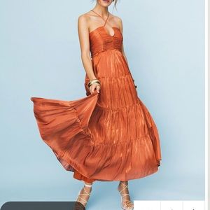 Rust colored tiered dress with adjustable straps. From few moda